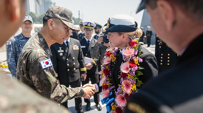 Republic of Korea Navy Commander Dae-Joong Lee shakes hands with Commanding Officer HMAS Hobart, Commander Tina Brown during an official welcome meeting in Busan, Republic of Korea as part of HMAS Hobart's regional presence deployment. Photo by Leading Seaman Matthew Lyall.